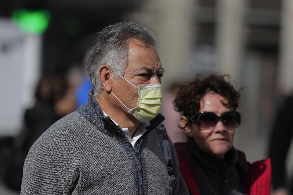 A man wears a face mask in central Madrid, Spain, Monday, March 9, 2020. Health authorities in the Madrid region say that infections for the new coronavirus have more than doubled in the past 24 hours. (AP Photo/Manu Fernandez)