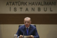 Turkey's President Recep Tayyip Erdogan speaks to the media before traveling to Berlin for a summit on Libya, in Istanbul, Sunday, Jan. 19, 2020. Erdogan expressed doubt Friday that Khalifa Hifter, the head of the self-styled Libyan National Army, would abide by the cease-fire. "This man is not a trust-worthy man," he told reporters in Istanbul. (Presidential Press Service/Pool Photo via AP)