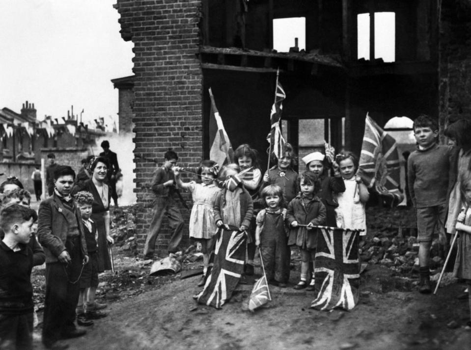 Children celebrate VE Day, marking the end of the war in Europe in 1945, amid the ruins of their bombed homes in Battersea, London (PA) (PA Wire)