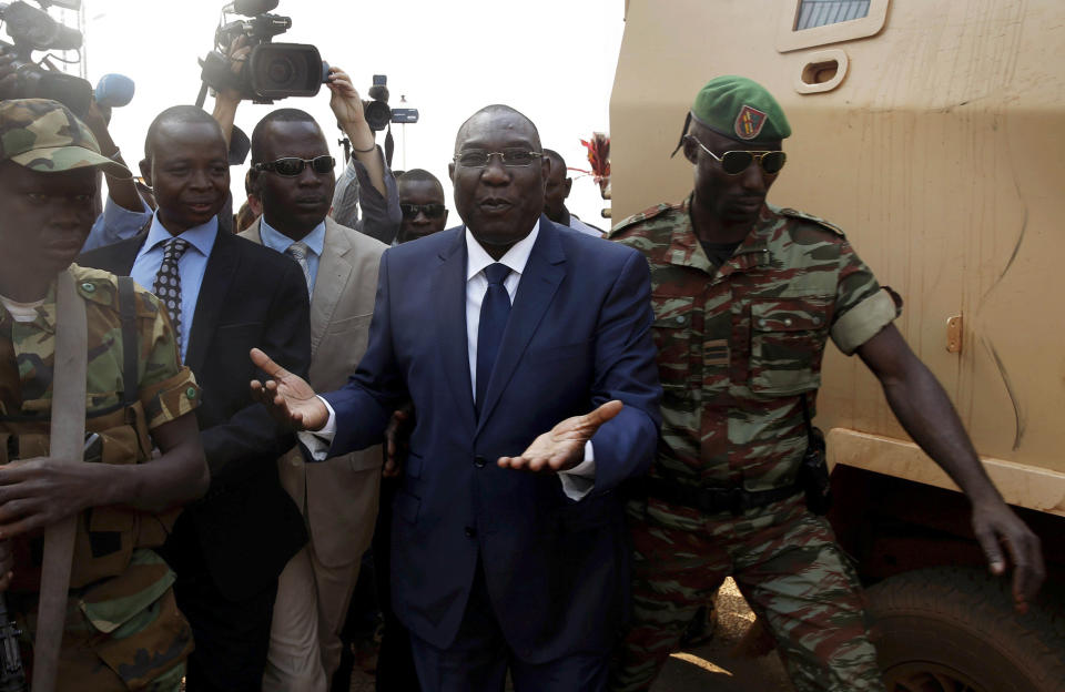 FILE _ This is a Thursday Dec. 19, 2013 file photo of Michel Djotodia, Central African Republic's president, as he walks back to the Chadian armored vehicle he arrived in following his meeting with US Ambassador to the United Nations Samantha Power at the airport in Bangui, Central African Republic. Djotodia, agreed to resign Friday Jan. 10, 2014 along with his prime minister, regional officials announced. The move comes following growing pressure for Djotodia to step aside and should help placate the armed militias who have used to violence to seek his ouster. However, his departure could also create an even greater power vacuum in a land that has long known coups and dictatorship. (AP Photo/Jerome Delay, File)