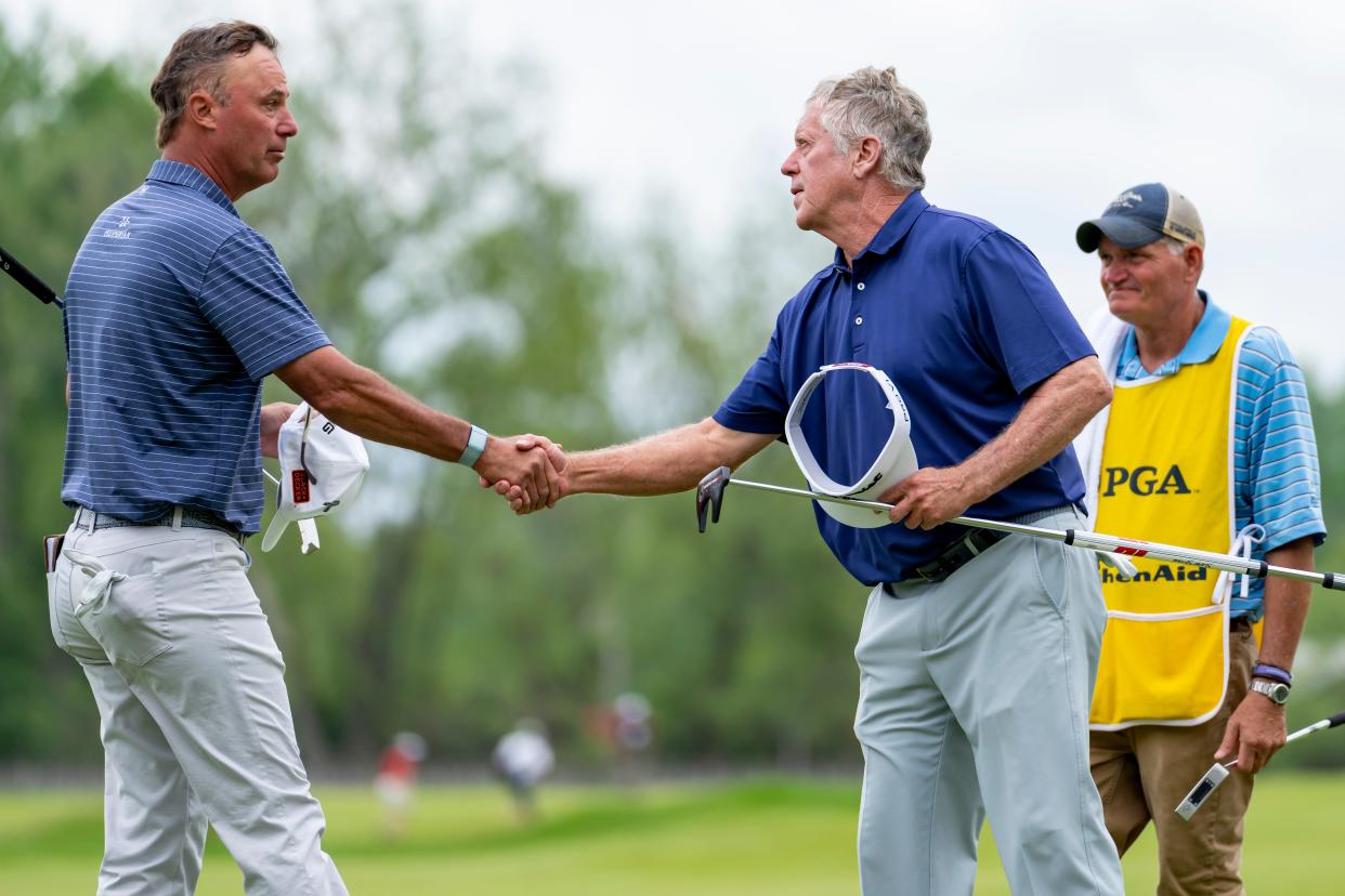 May 26, 2022; Benton Harbor, Michigan, USA; Chris Dimarco shakes hands with Michael Allen on the eighteenth green just after their first round of the 2022 KitchenAid Senior PGA Championship at Harbor Shores. Mandatory Credit: Raj Mehta-USA TODAY Sports