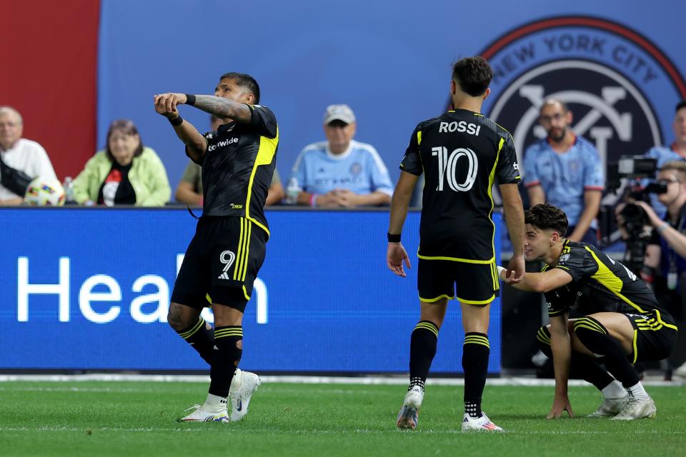 Jun 14, 2024; Bronx, New York, USA; Columbus Crew forward Cucho Hernandez (9) mimics a baseball swing as he celebrates his goal against New York City FC with forward Diego Rossi (10) and forward Max Arfsten (27) during the second half at Yankee Stadium. Mandatory Credit: Brad Penner-USA TODAY Sports