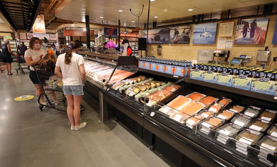 Shoppers browse the fresh food cases on the opening day of the Wegmans in Harrison, Aug. 5, 2020. 