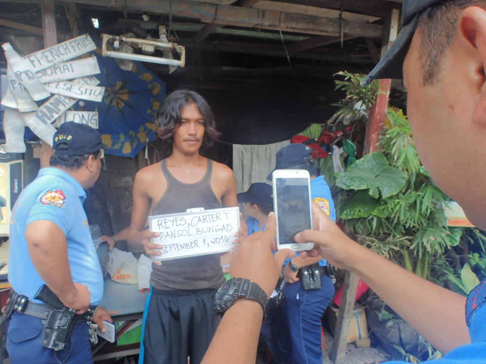 <p>Police profile a surrendered drug user in Pansol, Quezon City, Philippines on Sept. 1, 2016. (Sherbien Dacalanio/Pacific Press/LightRocket via Getty Images) </p>