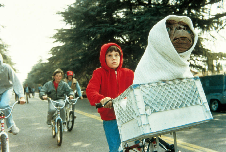 E.T. and Elliott take flight in E.T. the Extra-Terrestrial. (Photo: ©Universal/Courtesy Everett Collection)