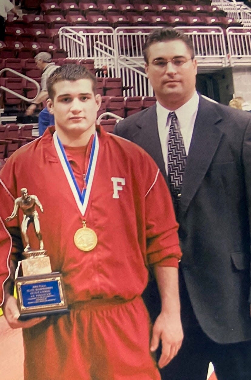 ohn Rosa, Freedom's wrestling coach from 1990-2007, poses with Kurt Brenner at the Giant Center in Hershey after Brenner won the third of his three state championships in the 171-pound weight class in 2002, '03 and '04.