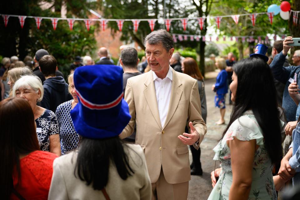 Vice Admiral Sir Tim Laurence, speaks with residents as he joins the Princess Royal in a visit to a Coronation Big Lunch in Swindon. Thousands of people across the country are celebrating the Coronation Big Lunch on Sunday to mark the crowning of King Charles III and Queen Camilla. Picture date: Sunday May 7, 2023.