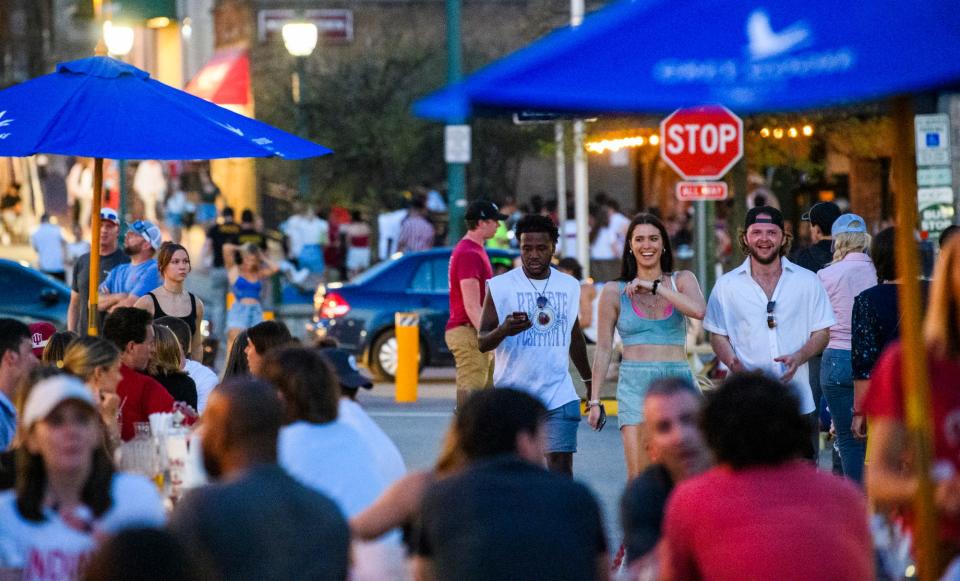 People walk down a busy East Kirkwood Avenue on Saturday night during Indiana University's Little 500 weekend. The street is blocked off for pedestrians and outside dining during warm weather months.