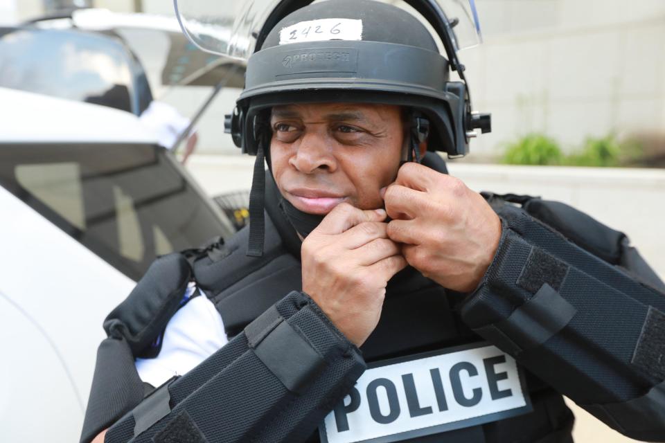 Columbus police Officer Phillip Jackson checks his riot gear as his downtown shift begins Wednesday. He is normally assigned to patrol the Linden neighborhood, but has been on the front lines facing protesters seeking racial justice.