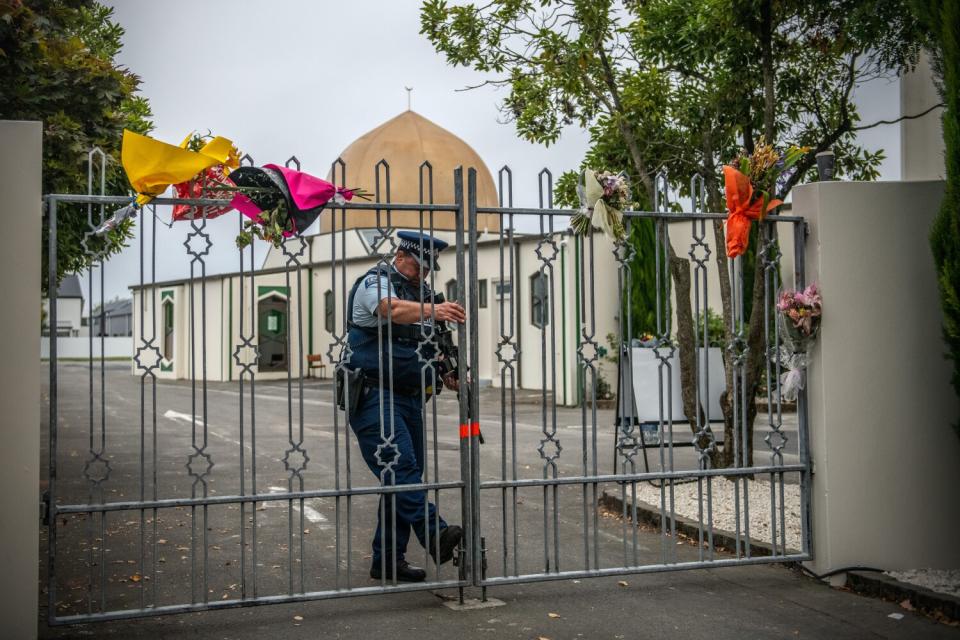 An armed police officer closes a gate to Al Noor Mosque after it was reopened in Christchurch, New Zealand, in 2019.