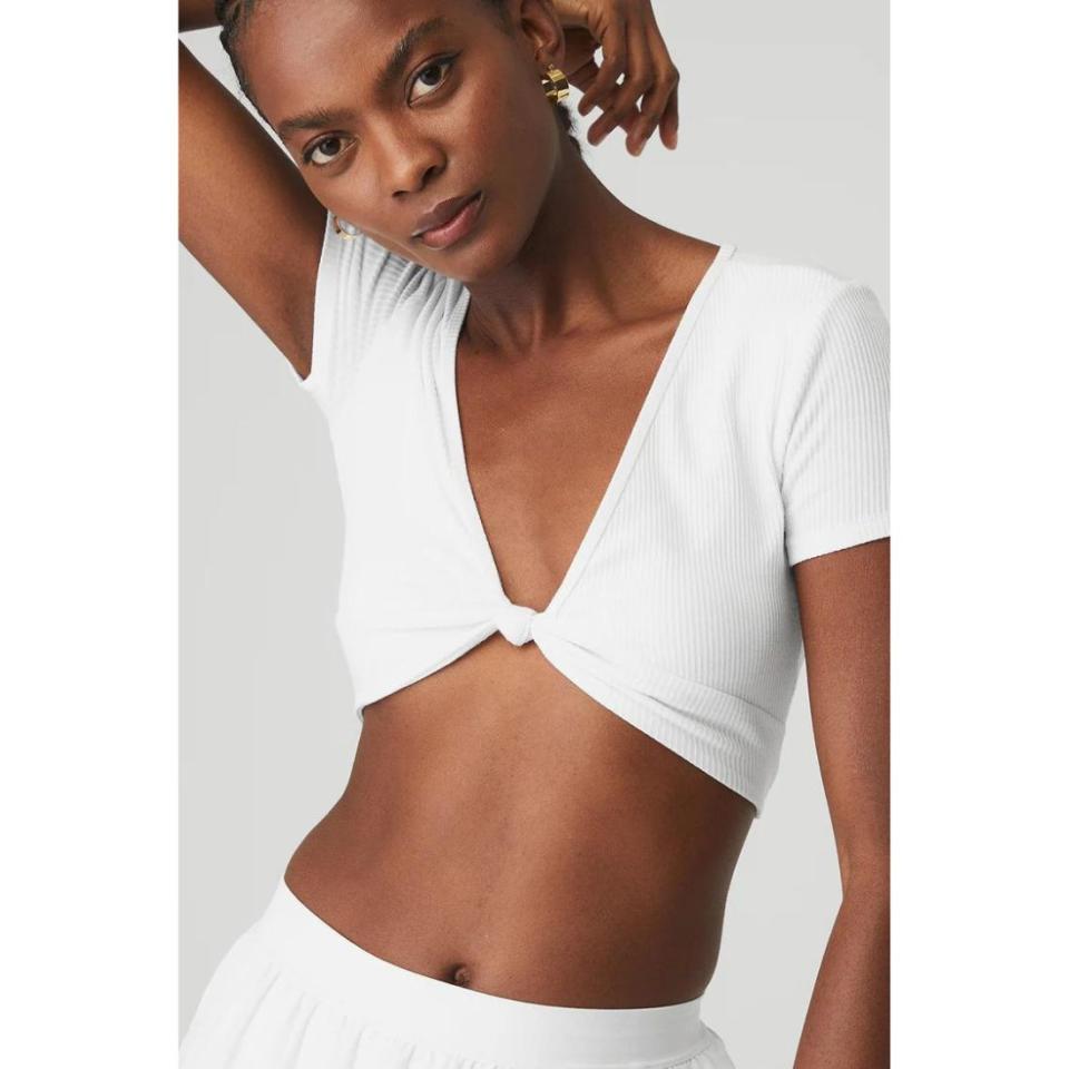 model wearing white knot twist crop top with matching skirt