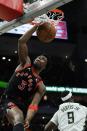 Toronto Raptors' OG Anunoby dunks during the first half of an NBA basketball game against the Milwaukee Bucks Saturday, Jan. 15, 2022, in Milwaukee. (AP Photo/Morry Gash)