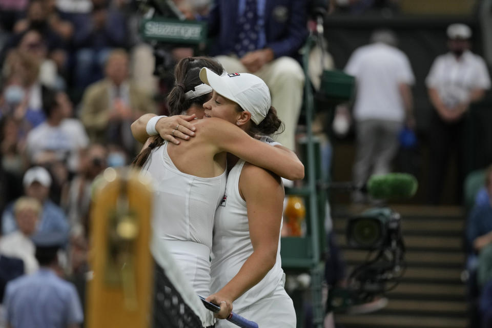 Australia's Ashleigh Barty, right, hugs compatriot Ajla Tomljanovic at the end of the women's singles quarterfinals match on day eight of the Wimbledon Tennis Championships in London, Tuesday, July 6, 2021. Barty won the match 6-1, 6-3. (AP Photo/Kirsty Wigglesworth)