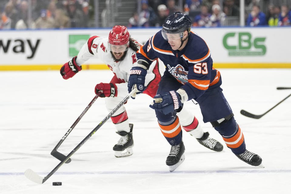 New York Islanders center Casey Cizikas (53) skates against Carolina Hurricanes defenseman Jalen Chatfield (5) during the second period of an NHL hockey game, Saturday, Jan. 21, 2023, in Elmont, N.Y. (AP Photo/Mary Altaffer)