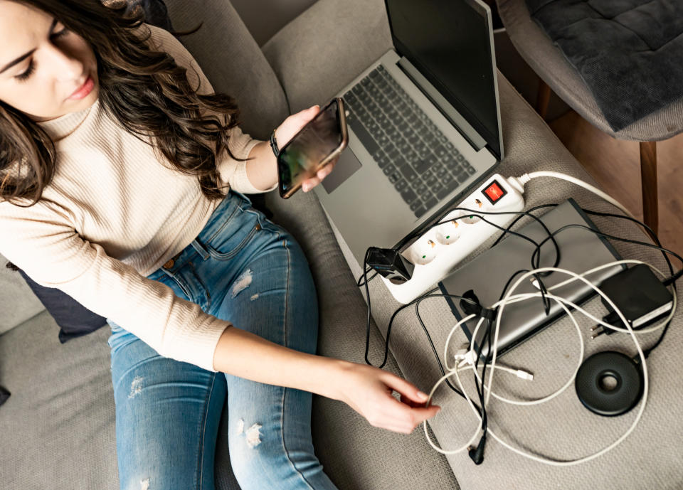 a woman with a phone charger and laptop