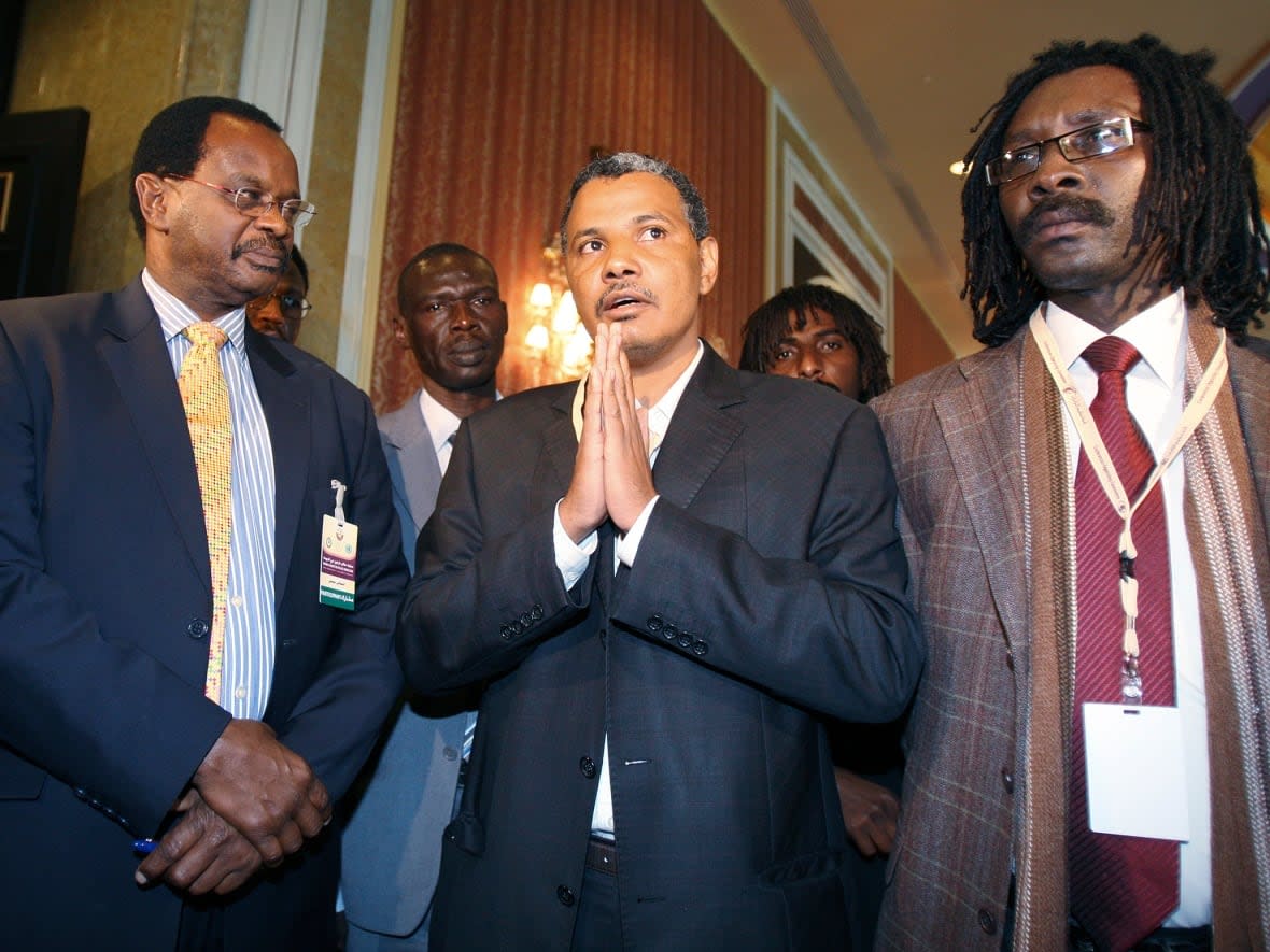 Yousif Ibrahim Ismaeil, centre, who is currently working as a political adviser to a general in Sudan's internal conflict is pictured in a 2010 file photo during a truce ceremony in Doha, Qatar related to previous violence in the country.  (Mohammed Dabbous/Reuters - image credit)