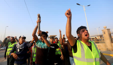 Iraqi demonstrators shout slogans during an anti-government protest in front of the Governorate building in Basra, Iraq December 14, 2018. REUTERS/Essam al-Sudani