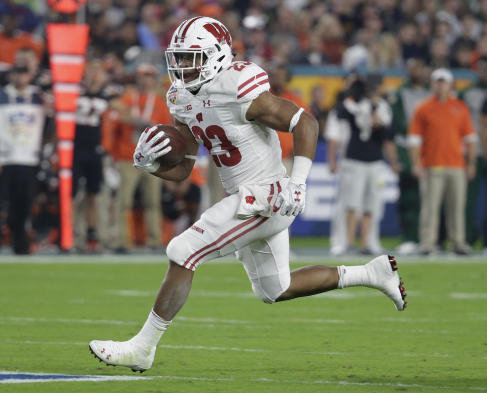 Wisconsin running back Jonathan Taylor (23) runs the ball during the first half of the Orange Bowl NCAA college football game against Miami, Saturday, Dec. 30, 2017, in Miami Gardens, Fla. (AP Photo/Lynne Sladky)