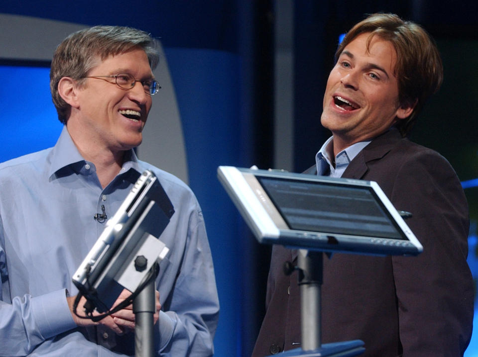 Jeff Raikes, group vice president of the Productivity and Business Systems Group at Microsoft, left, jokes around with Actor Rob Lowe, as he describes his experiences using a Tablet PC at the product launch event in New York City, Thursday, Nov. 7, 2002. Tablet PCs combine the full power of the Windows XP Tablet PC Edition operating system with the capability to use a digital pen in addition to a keyboard or mouse. (AP Photo/Suzanne Plunkett)