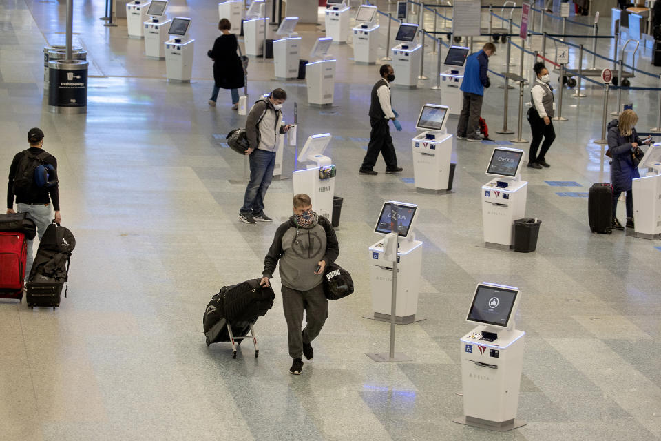 FILE - In this Nov. 12, 2020, file photo, travelers make their way through the Minneapolis-St. Paul International Airport during the coronavirus pandemic. With the coronavirus surging out of control, the nation’s top public health agency advised Americans on Thursday, Nov. 19, not to travel for Thanksgiving and not to spend the holiday with people from outside their household.(Elizabeth Flores/Star Tribune via AP, File)