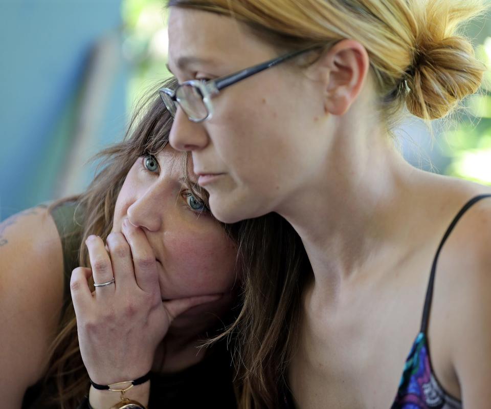 Meghan Meeker, left, is comforted by Beth Vild as they join other local women on Akron City Councilwoman Nancy Holland's front porch to discuss the Supreme Court's decision to overturn Roe v. Wade on Friday.