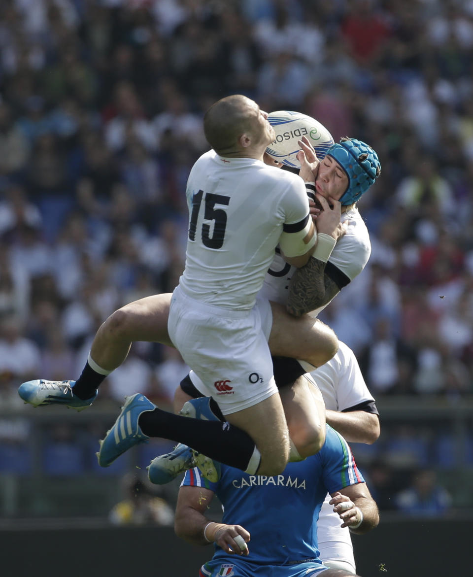 England's Mike Brown, left, and his teammate Jack Nowell reach for the ball during a Six Nations rugby union international match between Italy and England, in Rome, Saturday, March 15, 2014. (AP Photo/Alessandra Tarantino)