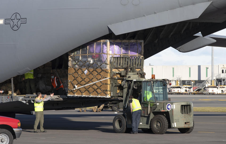 Ground crew load cargo onto a U.S. Air Force C-17 as they prepare to take the season's first flight to McMurdo Station in Antarctica from Christchurch Airport, New Zealand, Monday, Sept. 14, 2020. The first U.S. flight into Antarctica following months of winter darkness left from New Zealand Monday with crews extra vigilant about keeping out the coronavirus. (AP Photo/Mark Baker)