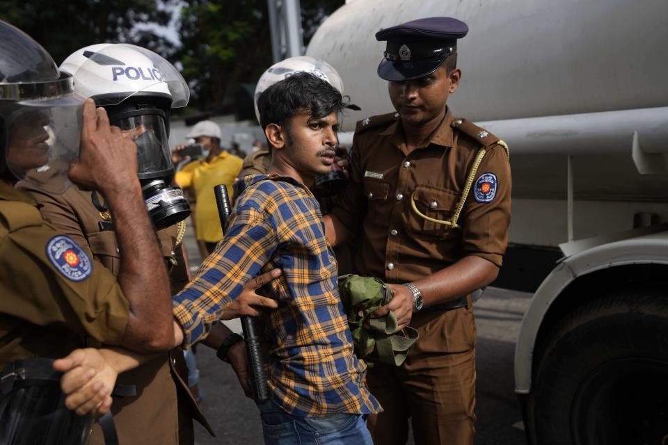 Police officers detain an anti-government protester in Colombo, Sri Lanka, Thursday, Aug. 18, 2022. Sri Lanka’s economic meltdown has triggered a political crisis, with widespread anti-government protests erupting across the country. Massive public protests ousted Sri Lankan President Gotabaya Rajapaksa last month. (AP Photo/Eranga Jayawardena)