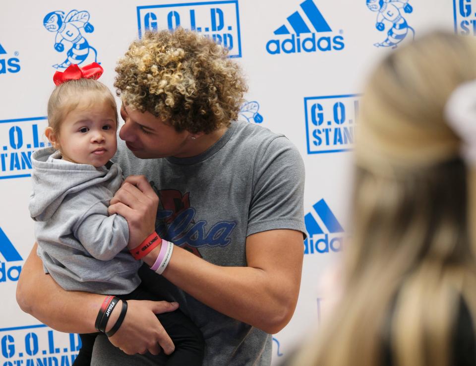 Choctaw outside linebacker Will Smith signed with the University of Tulsa, holds his niece, Ella Smith, 2, for a photo by her mother and Will's sister, Maddie Smith, Wednesday, Dec. 20, 2023.
