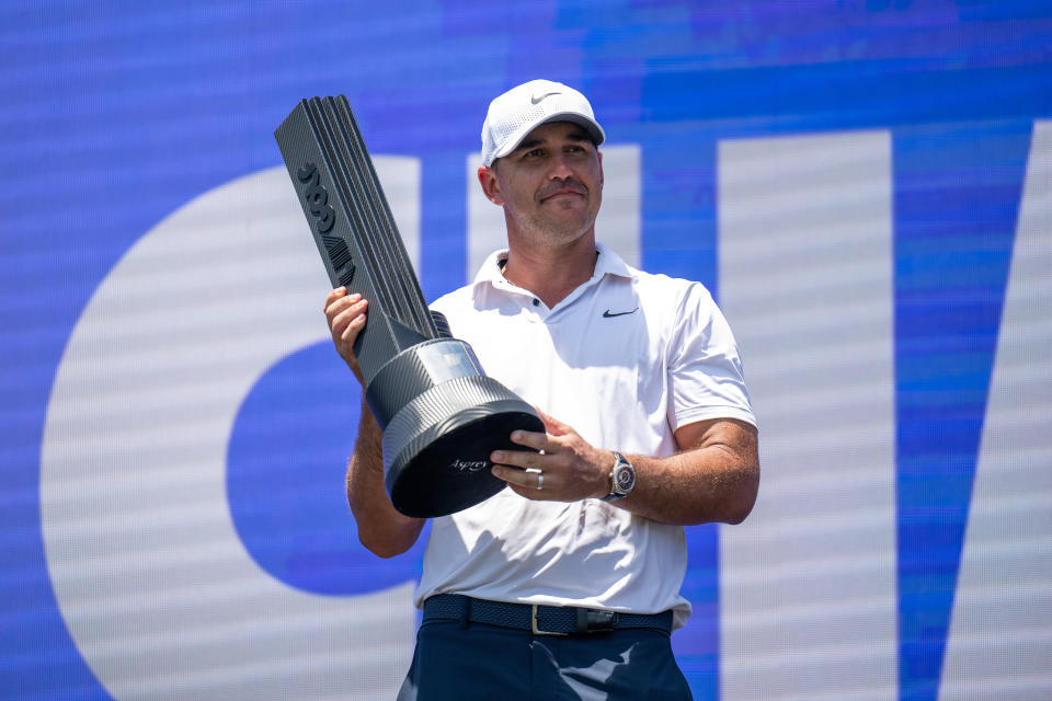American golfer Brooks Koepka holds aloft the trophy after winning the LIV Golf Singapore tournament at Sentosa Golf Club. 
