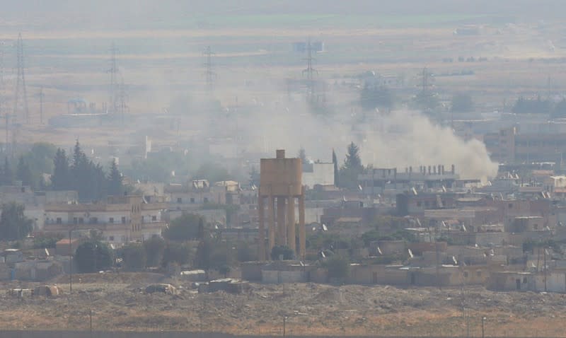 Smoke rises over the Syrian town of Ras al-Ain as seen from the Turkish border town of Ceylanpinar