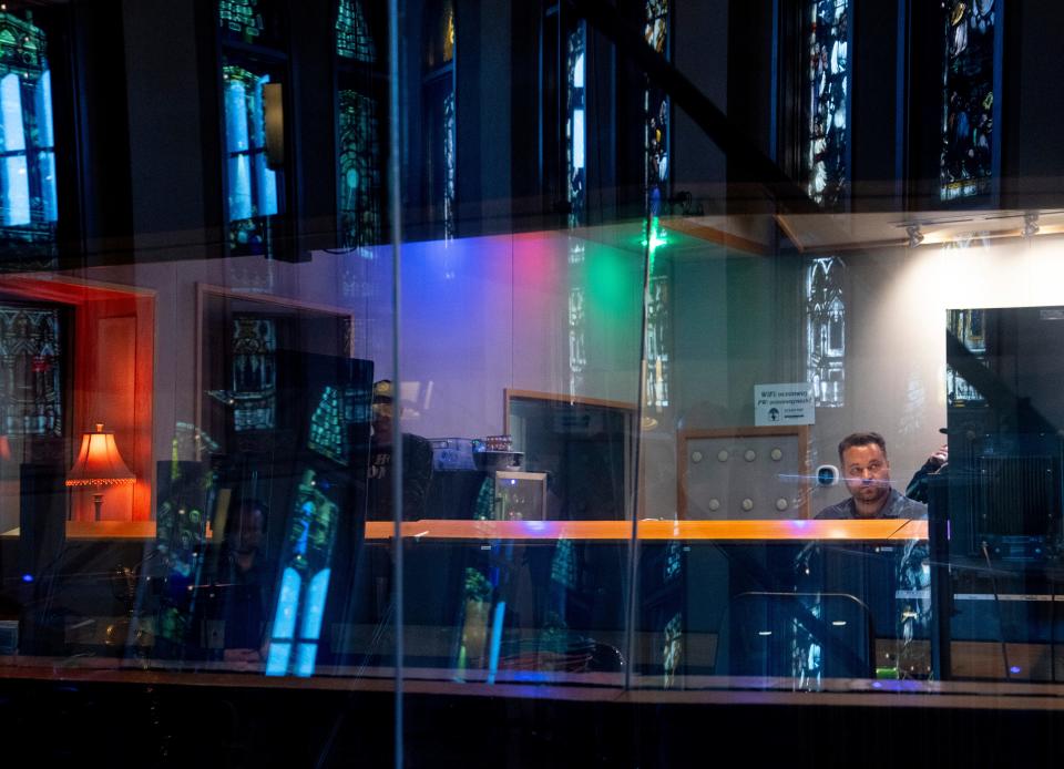 Stained glass windows are reflected in the windows of the control room as work continues on the theme song and musical track for EA Sports' "College Football 25" in Studio A at Ocean Way Nashville in Nashville, Tenn., Saturday, March 16, 2024.