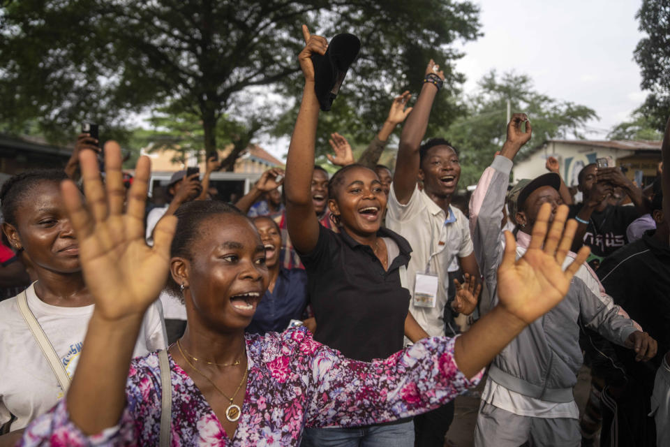 Supporters of President Felix Tshisekedi cheer him on after he cast his ballot inside a polling station during the presidential elections in Kinshasa, Democratic Republic of Congo, Wednesday, Dec. 20, 2023. Congo saw opening delays of up to seven hours in a presidential election Wednesday facing steep logistical and security challenges that raised questions about the credibility of the vote. (AP Photo/Mosa'ab Elshamy)