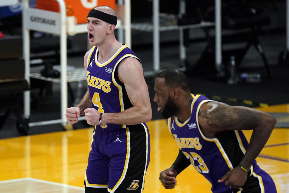 Los Angeles Lakers guard Alex Caruso (4) reacts after scoring during the second half of an NBA basketball game against the Portland Trail Blazers Friday, Feb. 26, 2021, in Los Angeles. Los Angeles Lakers forward LeBron James (23) is at right. (AP Photo/Mark J. Terrill)