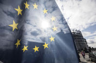 An EU flag flies at the front of the European Parliament building in Strasbourg, France, Tuesday March 26, 2019. The European Parliament is furiously debating the pros and cons of a landmark copyright bill one last time before the legislature will vote on it later. (AP Photo/Jean-Francois Badias)