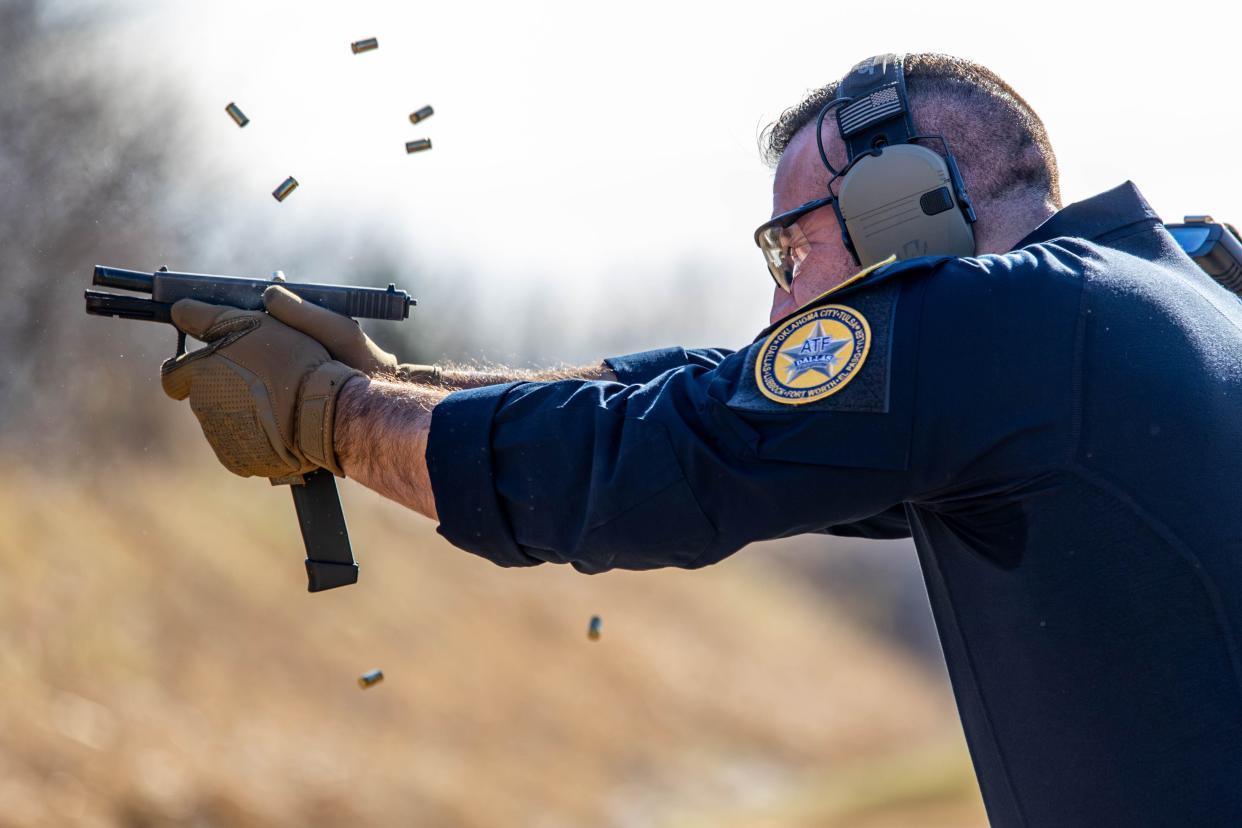 ATF agent Jared Lowe fires a modified handgun during a November demonstration by federal prosecutors in Oklahoma City. The Bureau of Alcohol, Tobacco, Firearms and Explosives does not allow people unlawfully in the U.S. to buy or own guns.