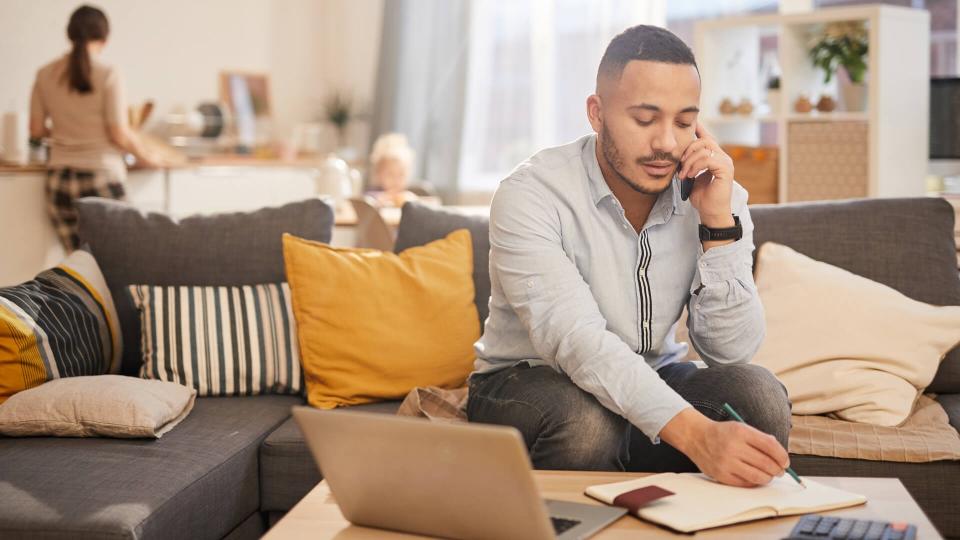 dad working at home with wife and kid in kitchen