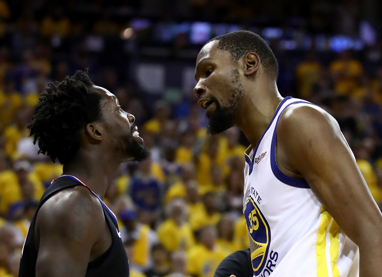 OAKLAND, CALIFORNIA - APRIL 13:   Kevin Durant #35 of the Golden State Warriors has words with Patrick Beverley #21 of the LA Clippers during Game One of the first round of the 2019 NBA Western Conference Playoffs at ORACLE Arena on April 13, 2019 in Oakland, California. Both players were ejected later in the game.  NOTE TO USER: User expressly acknowledges and agrees that, by downloading and or using this photograph, User is consenting to the terms and conditions of the Getty Images License Agreement. (Photo by Ezra Shaw/Getty Images)