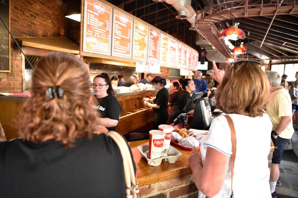 Hundreds of people came out for the closing day of The Fireplace restaurant in Paramus, N.J. on Friday July 30, 2021. The line wrapped around the parking lot as people waited to get their last burger fries and pickles from the establishment. 