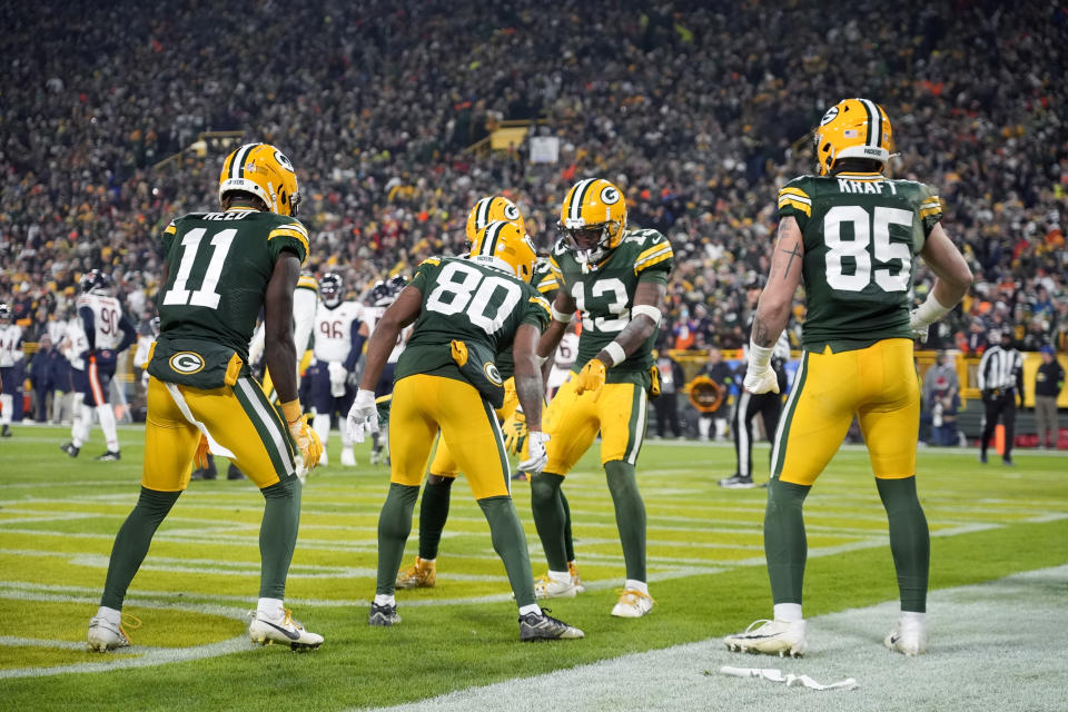 Green Bay Packers wide receiver Dontayvion Wicks (13) celebrates with teammates after making a touchdown catch during the second half of an NFL football game against the Chicago Bears Sunday, Jan. 7, 2024, in Green Bay, Wis. (AP Photo/Morry Gash)