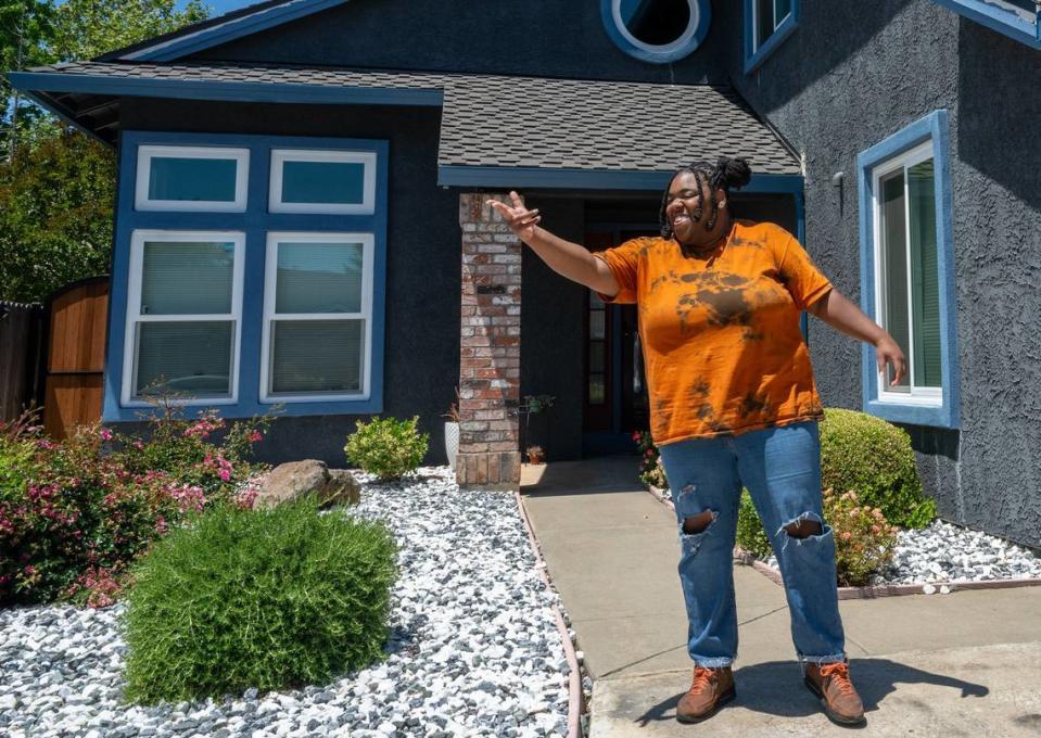 Arlysia Harris stands Tuesday outside the home near Elk Grove where she lives with her parents. “I feel like in this day and time they are kind of designing the world for people to still live at home with their parents,” Harris said. “To make the world run, you got to make it economically available for people in a way to where they are not struggling so much to get by.”