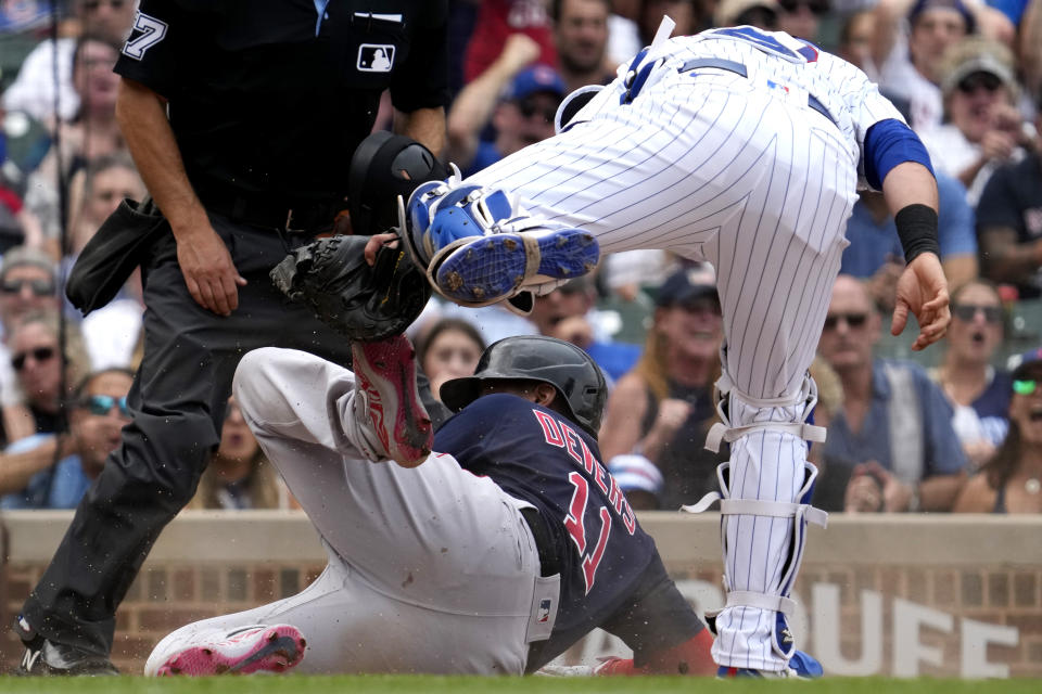 Chicago Cubs catcher Yan Gomes, top right, tags out Boston Red Sox's Rafael Devers, bottom, at home during the fourth inning of a baseball game in Chicago, Sunday, July 16, 2023. (AP Photo/Nam Y. Huh)