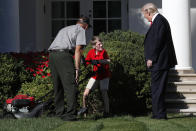 <p>Frank Giaccio, 11, of Falls Church, Va., turns his head as he is surprised by President Donald Trump while mowing the lawn of the Rose Garden, Friday, Sept. 15, 2017, at the White House in Washington. The 11-year-old, who wrote the president requesting to mow the lawn at the White House, was so focused on the job at hand the he didn’t notice the president until he was right next to him. At left is a member of the National Park Service. (Photo: Jacquelyn Martin/AP) </p>