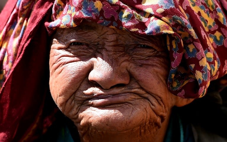 <p>In this photograph taken on September 16, 2016, a Buddhist devotee looks on during the Naropa festival, popularly known as the ‘Kumbh Mela of the Himalaya’, a Buddhist gathering that takes place once every twelve years at Hemis village in Leh. Hundreds of thousands of villagers, monks and tourists flocked to India’s mountainous region of Ladakh for a Buddhist celebration held once in 12 years, popularly known as the ‘Kumbh Mela of the Himalayas’. / AFP PHOTO / MONEY SHARMA </p>