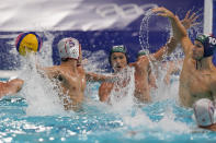 Japan's Takuma Yoshida (5) winds up to shoot against Hungary's Denes Varga (10) during a preliminary round men's water polo match at the 2020 Summer Olympics, Tuesday, July 27, 2021, in Tokyo, Japan. (AP Photo/Mark Humphrey)