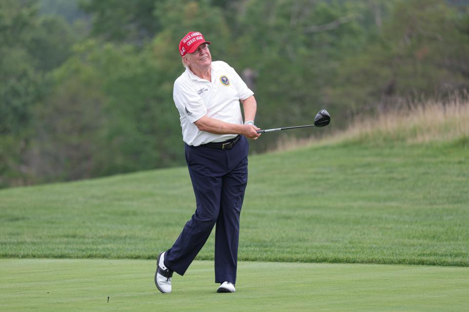 Former President Donald Trump plays his shot from the ninth tee during the ProAm round of the LIV Golf Bedminster golf tournament at Trump National Bedminster.