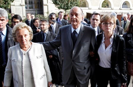 FILE PHOTO: File photo of former French President Chirac walking between his wife Bernadette and daughter Claude as they leave the Musee du Quai Branly in Paris
