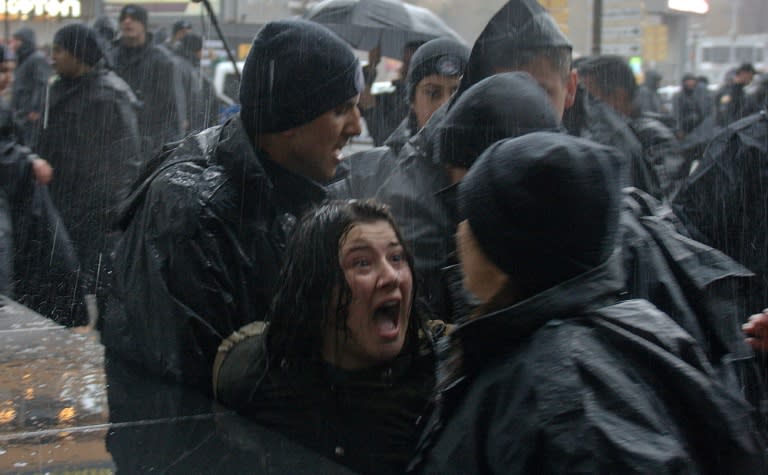 A woman protester shouts at Turkish riot police as they try to detain her during a rally for women's rights in Ankara which police broke out with tear gas