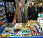 <p>Something catch your eye, Charles? The Prince stopped for a moment to examine the magazine stand at a post office in Cumbria, England. He's just like us and can't resist the goodies in the checkout line. </p>