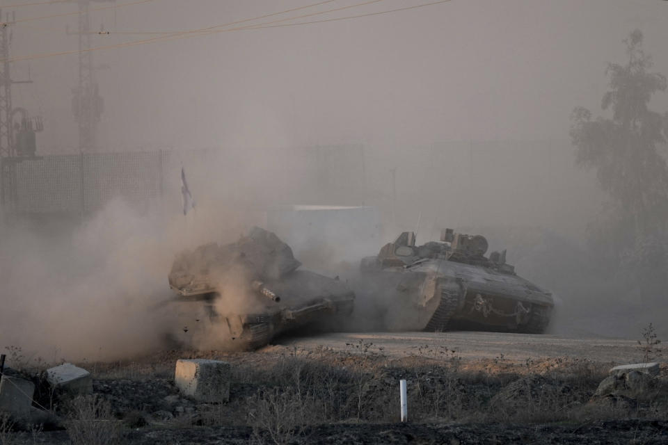 Israeli army tanks are seen near the Gaza Strip border, in southern Israel, Monday, Dec. 11, 2023. The army is battling Palestinian militants across Gaza in the war ignited by Hamas' Oct. 7 attack into Israel. (AP Photo/Ohad Zwigenberg)